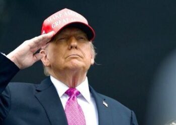 Donald Trump saluda militarmente con una gorra roja de "Make America Great Again", durante un acto público, en el contexto de sus declaraciones sobre un nuevo acuerdo comercial con Europa.